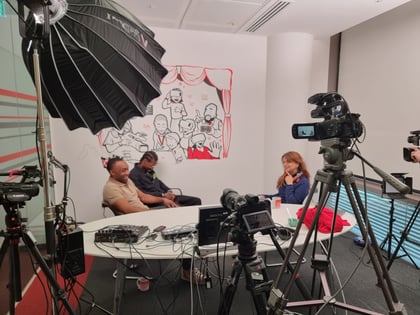 photo of 3 people being filmed for podcast